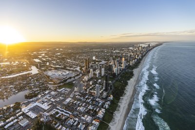 A dramatic sunrise aerial view of the Gold Coast, showcasing its skyline and coastline.