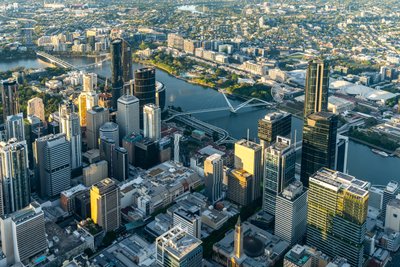 Aerial view over West End, Brisbane's inner city suburb with modern skyscrapers and the iconic Story Bridge.