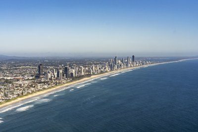 Aerial view of the Gold Coast coastline, featuring Surfers Paradise skyline and Pacific Ocean.