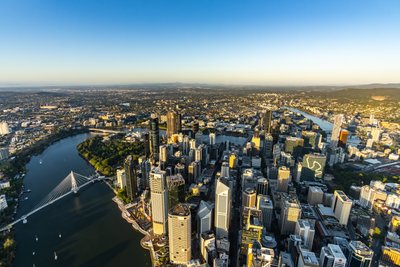 Aerial view over West End, Brisbane showing the city's skyline and infrastructure.