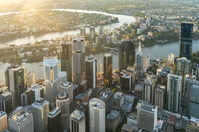 Aerial view over West End, Brisbane showcasing high-rise architecture and the city's waterfront.