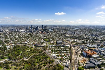 Aerial view of Brisbane western suburbs and motorway infrastructure leading to the CBD.