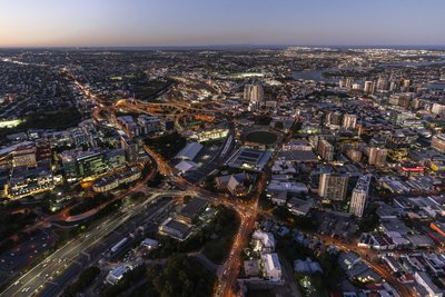 Aerial night view of illuminated streets and buildings in South Brisbane, Queensland.