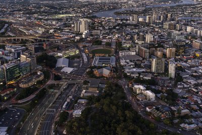 Aerial dusk view of Woolloongabba and inner south Brisbane suburbs looking toward the CBD.