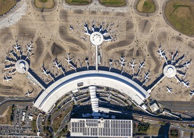 Overhead aerial view of Brisbane Airport's domestic terminal with aircraft parked at gates.