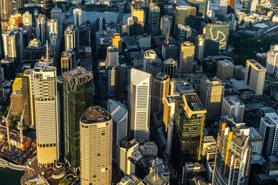 Aerial view over West End, Brisbane's inner city suburb with modern skyscrapers and riverside development.