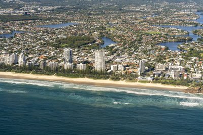 Aerial view of Gold Coast Broadbeach coastal suburb with beach, canals and residential waterways.