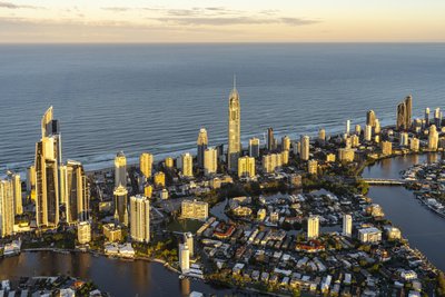 A close aerial view of Surfers Paradise with the Q1 Tower and Nerang River canal system in morning light.