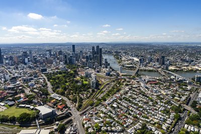 Aerial view of Brisbane CBD and surrounding suburbs with the Brisbane River snaking through the city.