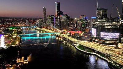 A stunning night aerial view of Brisbane CBD with illuminated bridges, river and city towers.