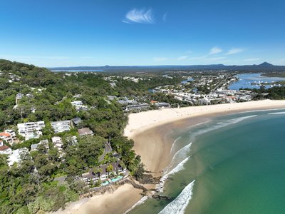 Aerial view of Noosa Heads looking south with Noosa National Park headland in foreground, Main Beach and Noosa township behind.