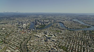 A high altitude aerial overview of Brisbane CBD with the Brisbane River, Gabba stadium and surrounding suburbs.